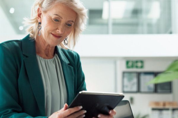 Business woman using an ipad in an office