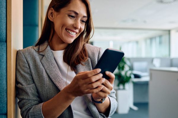 Real estate agent using a phone in an office