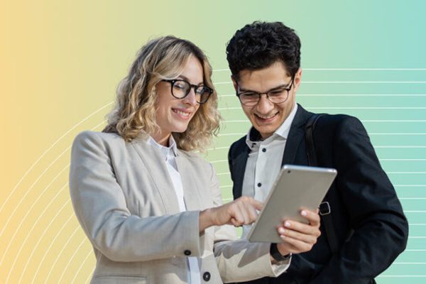 Estate agents using an ipad, smiling