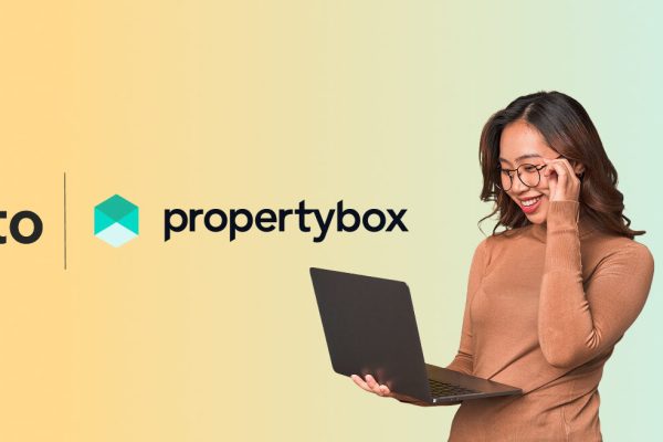 property box banner with woman holding a laptop and smiling