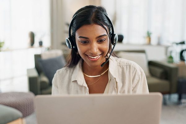 Real estate agent woman on a video call, smiling, working in an office