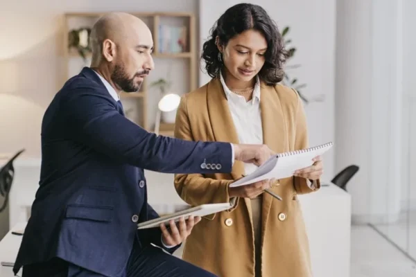 Two real estate agent looking at their notepad