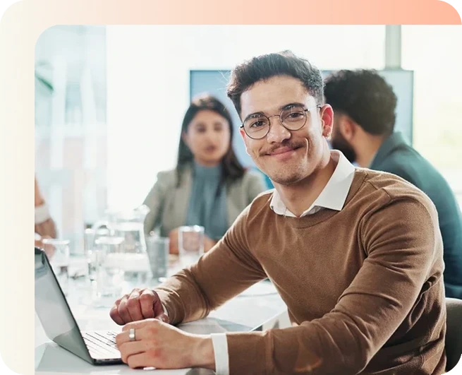 Real estate agent smiling working on his laptop