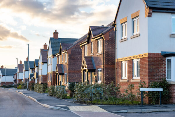 Houses In England With Typical Red Bricks At Sunset Main Stree