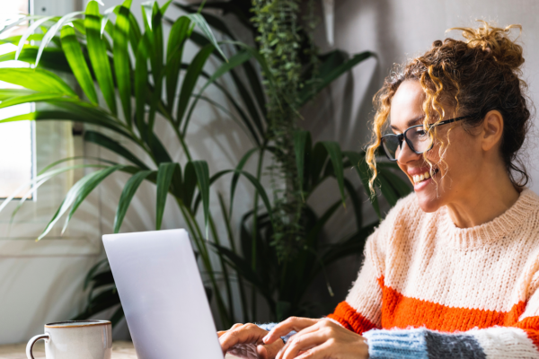 Smiling agent working on her laptop