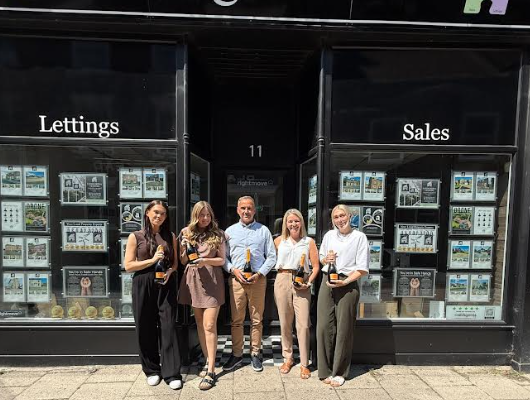 Team at jigsaw outside their office posing for a picture